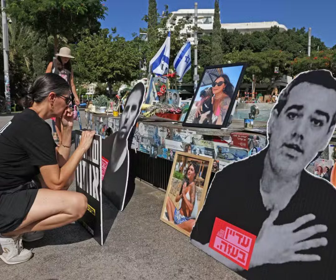 112624115-people-gather-around-a-fountain-turned-to-a-memorial-in-tel-aviv-for-israelis-killed-durin.jpeg