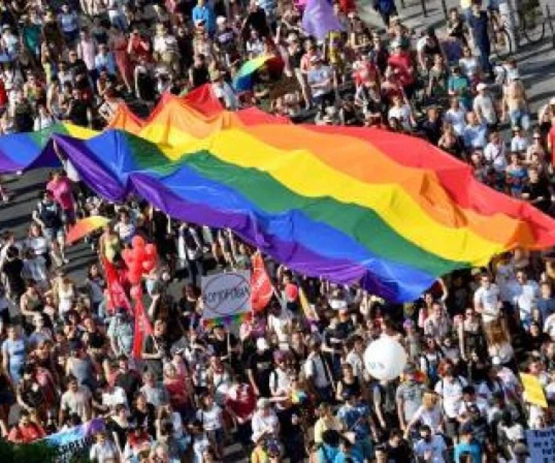 (FILES) In this file photo taken on July 06, 2019 people march with their giant rainbow flag during the lesbian, gay, bisexual and transgender (LGBT) Pride Parade from the parliament building in downtown Budapest. Hungary