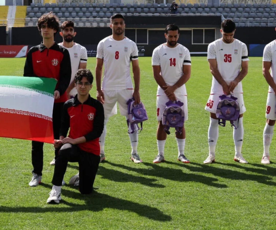 Jogadores iranianos de futebol seguram mochilas escolares em protesto