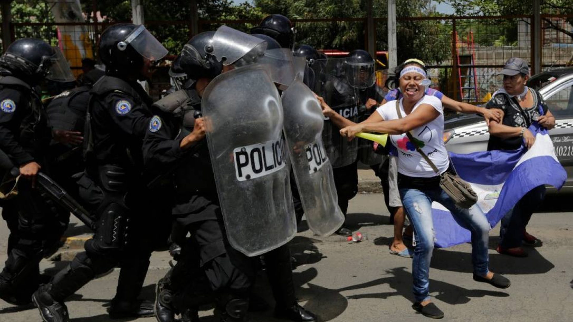 79009080_TOPSHOTWomen-clash-with-riot-police-blocking-a-street-during-a-protest-against-Nicaragua.jp_.jpeg